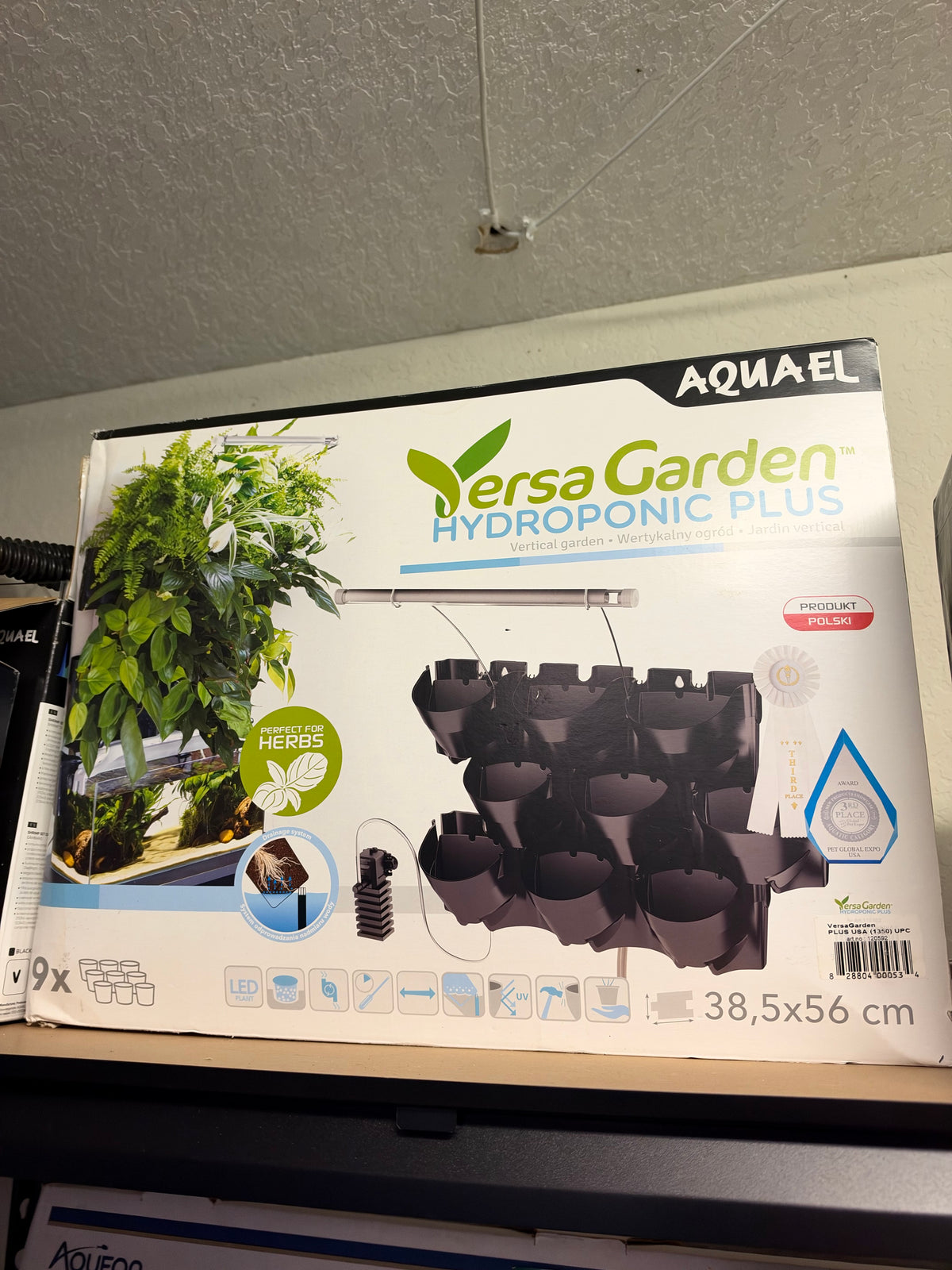 Aquael Versa Garden Hydroponic Plus indoor hydroponic garden with multiple plant compartments and LED grow lights.