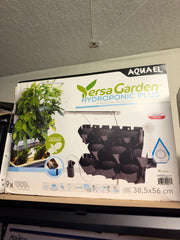 Aquael Versa Garden Hydroponic Plus indoor hydroponic garden with multiple plant compartments and LED grow lights.
