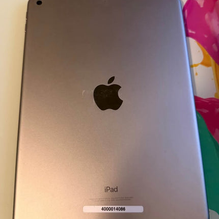 Apple iPad 6th Generation 128GB tablet with silver front and back, displaying its sleek design and home button.