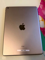 Apple iPad 6th Generation 128GB tablet with silver front and back, displaying its sleek design and home button.