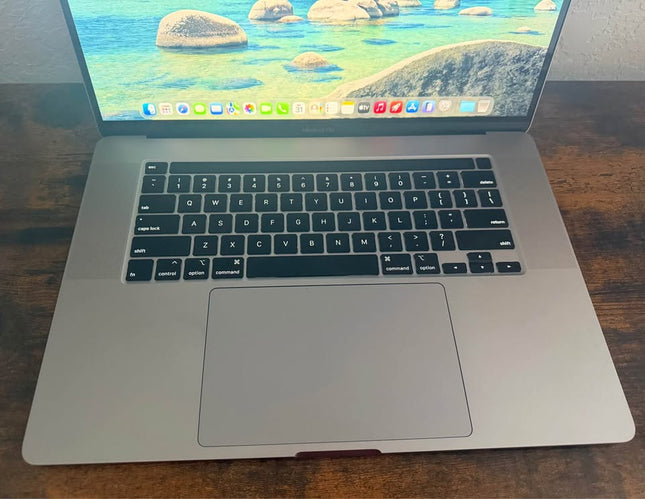 Apple MacBook Pro 2019 with Touch Bar open, showing keyboard and Retina display, in a sleek silver design