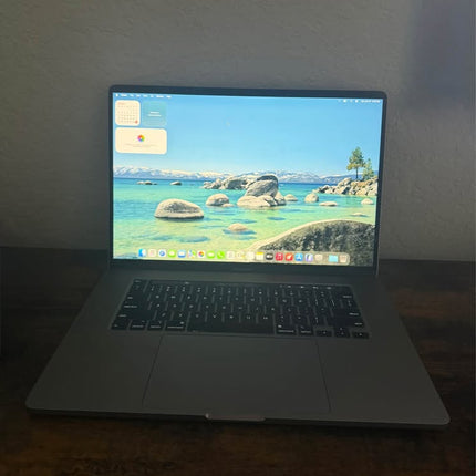 Apple MacBook Pro 16-inch with Touch Bar in Space Gray, open showing keyboard and high-resolution display.