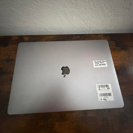Apple MacBook Pro 16-inch with Thunderbolt ports in space gray, showing the sleek laptop open on a desk.