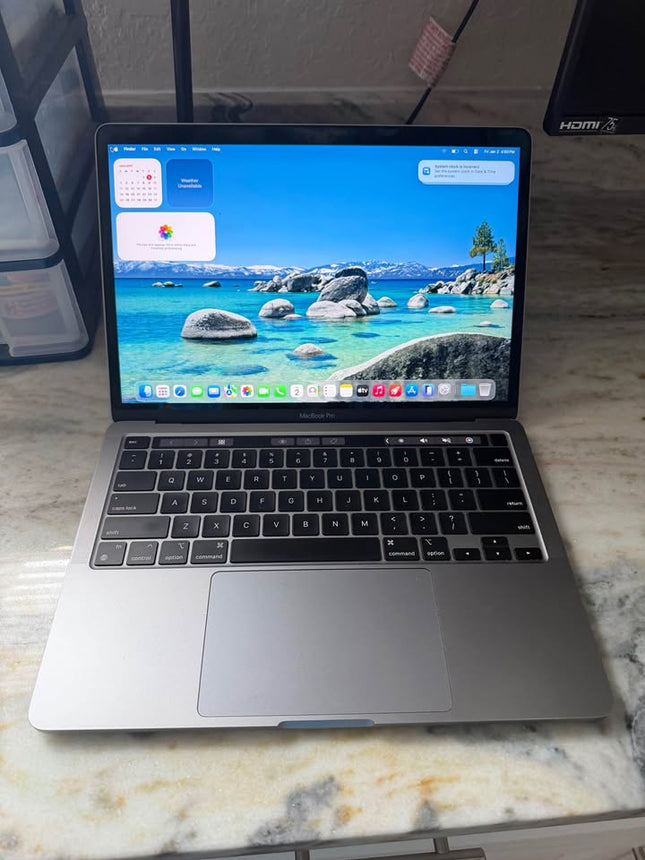 Apple MacBook Pro 2020 with Touch Bar, sleek silver laptop showing keyboard and screen with vibrant display.