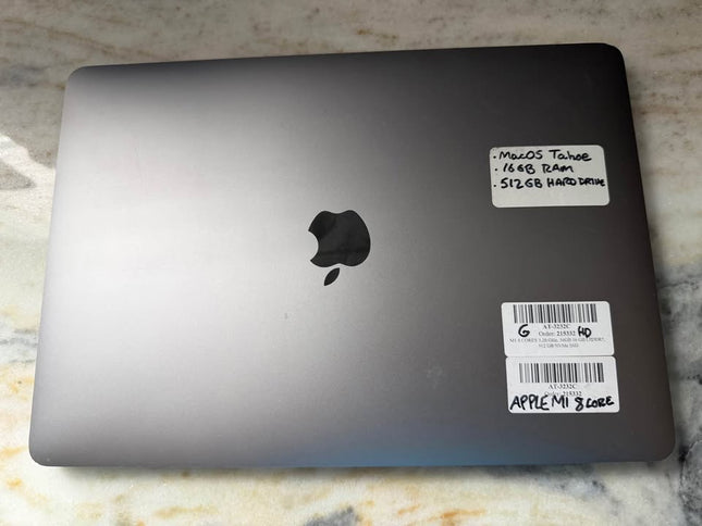 Apple MacBook Pro 2020 with Touch Bar, sleek silver laptop open showing keyboard and Retina display screen.
